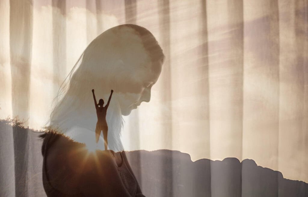 How to Manage Strong Emotions A silhouette of a person with long hair is overlaid with an image of another person standing on a mountain with arms raised in triumph. The background features soft, flowing curtains with light filtering through, creating a serene and uplifting atmosphere. Showing ABCs of Emotional Regulation