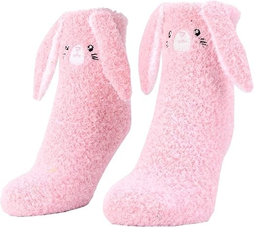Soft pink fuzzy bunny socks designed to provide warmth, comfort, and a touch of playfulness. Perfect for lifting a depressed mood by engaging the sense of touch and adding a cozy, cheerful element to self-care routines.